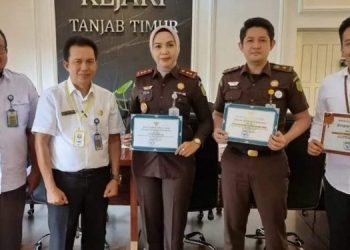 Penyerahkan piagam penghargaan kepada kepala Kejaksaan Negeri Tanjabtim Yenita Sari, SH.MH. oleh Kabag Hukum Setda, Idris, SH.MH di ruang kerja Kajari Tanjabtim (Dok. Rizon)